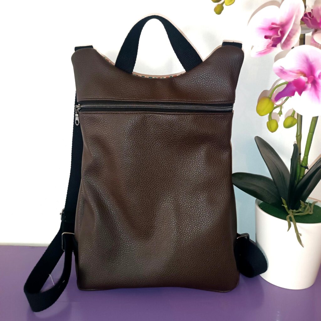 Zaino in pelle marrone handmade con zip frontale e spallacci neri.
